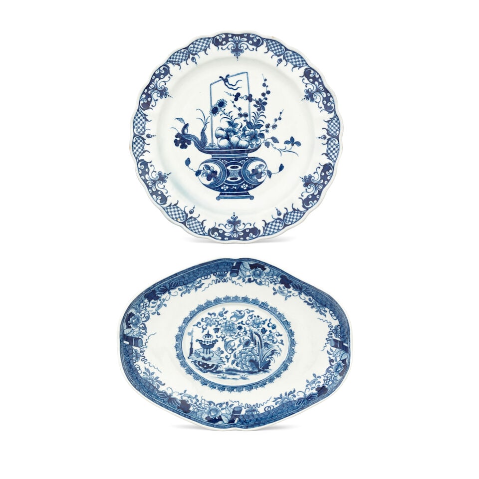 A rare Worcester plate and a tureen stand, circa 1770-75: A rare Worcester plate and a tureen stand, circa 1770-75 The dessert plate with a lobed rim, finely painted in blue with a stylised Chinese flower basket within a neat lambrequin border, 21.5cm diam, 