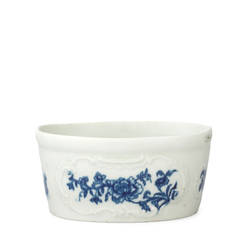 A rare Worcester potting pot, circa 1760: A rare Worcester potting pot, circa 1760 Of oval shape with a thickened rim, the exterior moulded with four scroll-edged panels, printed in blue to the interior with the 'Floral Gift' pattern (II.A.18