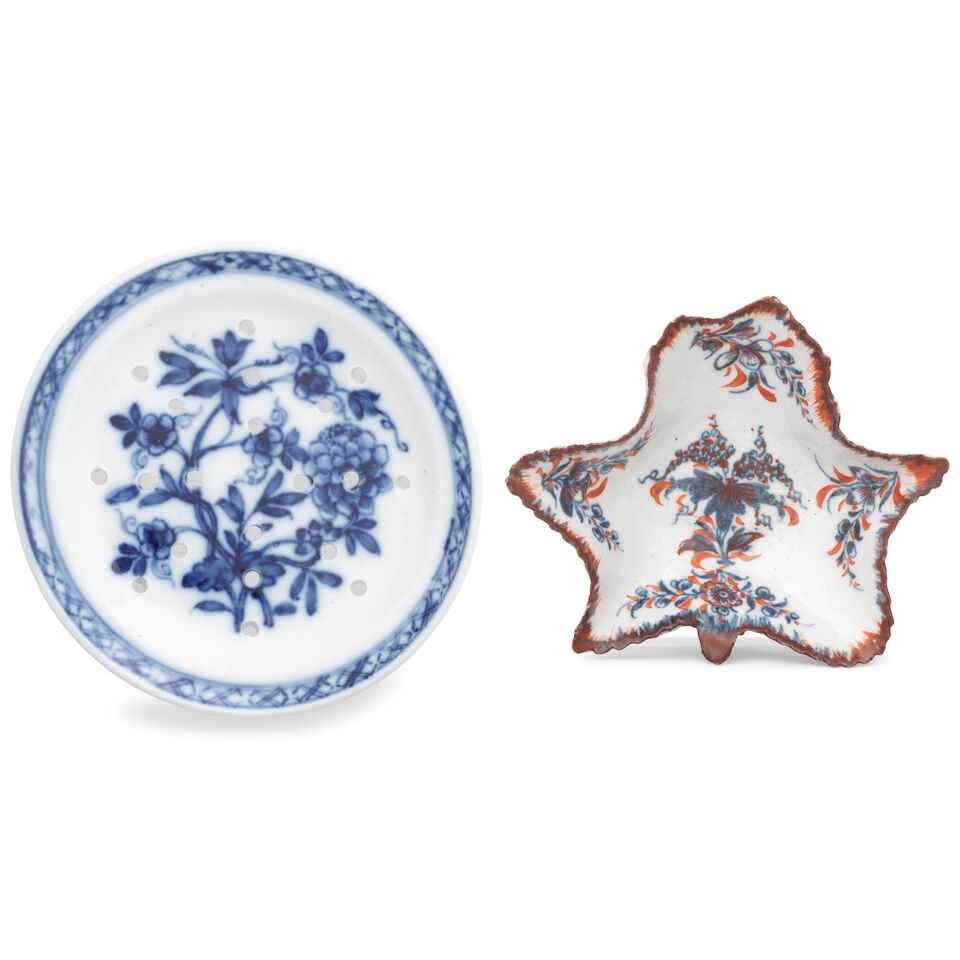 A Bristol strainer and Plymouth leaf pickle dish, circa 1768-75: A Bristol strainer and Plymouth leaf pickle dish, circa 1768-75 The first of circular shape, pierced with four intersecting lines of small holes, painted in blue with a flowering plant, the rim with
