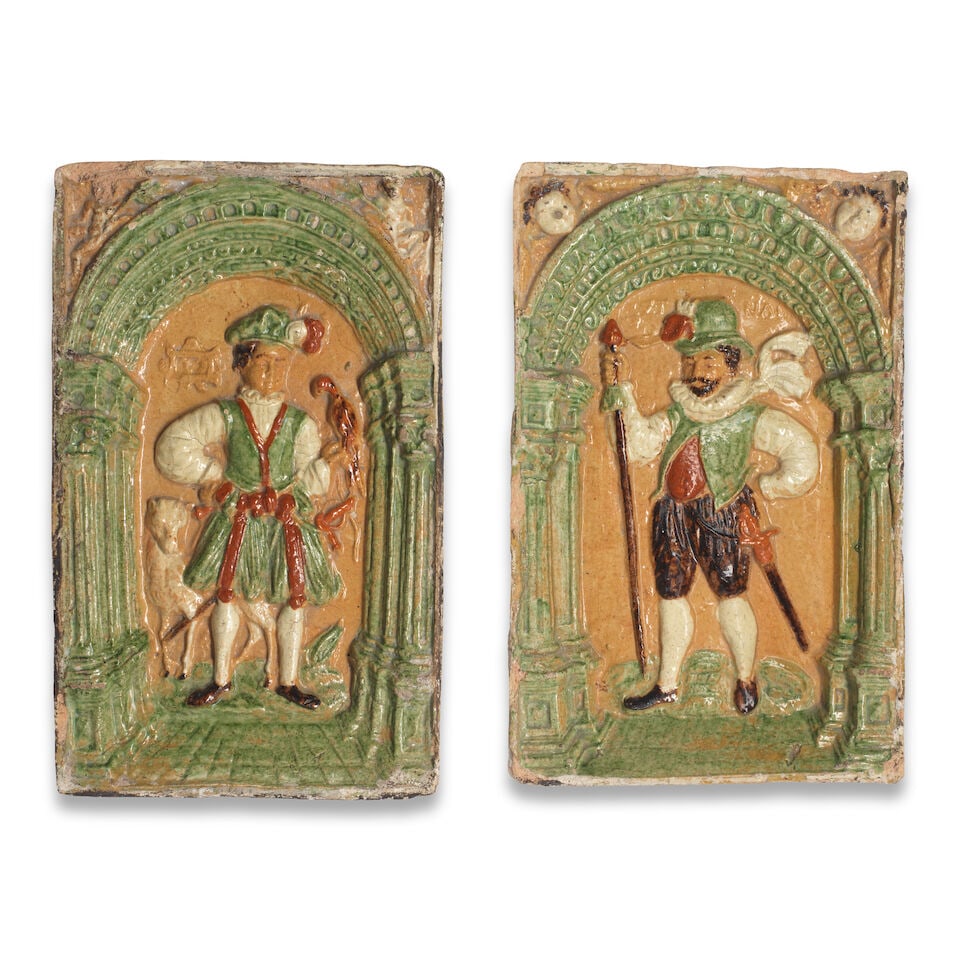 Two German lead-glazed rectangular stove tiles, probably Cologne, late 16th century: Two German lead-glazed rectangular stove tiles, probably Cologne, late 16th century Each moulded in relief and embellished with coloured glazes depicting a nobleman in a recessed interior below an