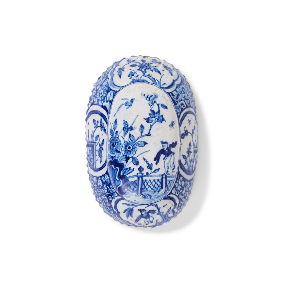 A Dutch Delft brushback, circa 1720-40: A Dutch Delft brushback, circa 1720-40 Decorated with a chinoiserie pattern of figures and sprays of flowers in blue and white, moulded with fluted sides, 15.5cm diam. Footnotes: A similarly