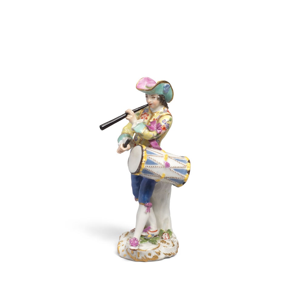 A Meissen later-decorated figure of a fife and drum player from the Cris de Paris series, the po...: A Meissen later-decorated figure of a fife and drum player from the Cris de Paris series, the porcelain circa 1760 Modelled by Peter Reinicke, wearing a puce and green hat, yellow jacket with