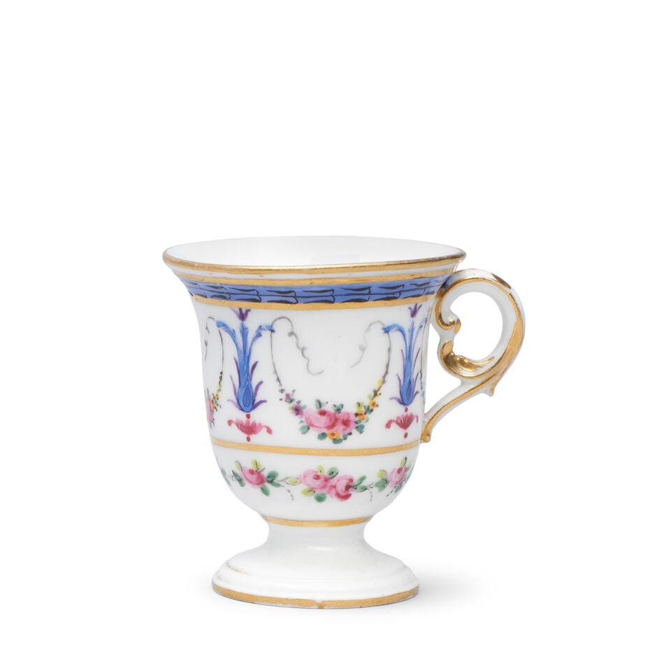 A Sèvres ice cream cup (tasse à glace), circa 1793-1800: A Sèvres ice cream cup (tasse à glace), circa 1793-1800 Painted by Michel-Gabriel Commelin with blue foliate motifs and floral swags between floral and blue borders, 6.6cm high, interlaced