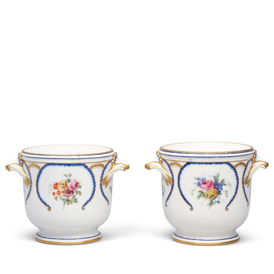 A pair of Sèvres glass coolers (seaux à verre), dated 1780: A pair of Sèvres glass coolers (seaux à verre), dated 1780 Painted by Denis Levé with scattered flower sprays and feuilles de choux panels in blue and gilding, the scroll and shell hand