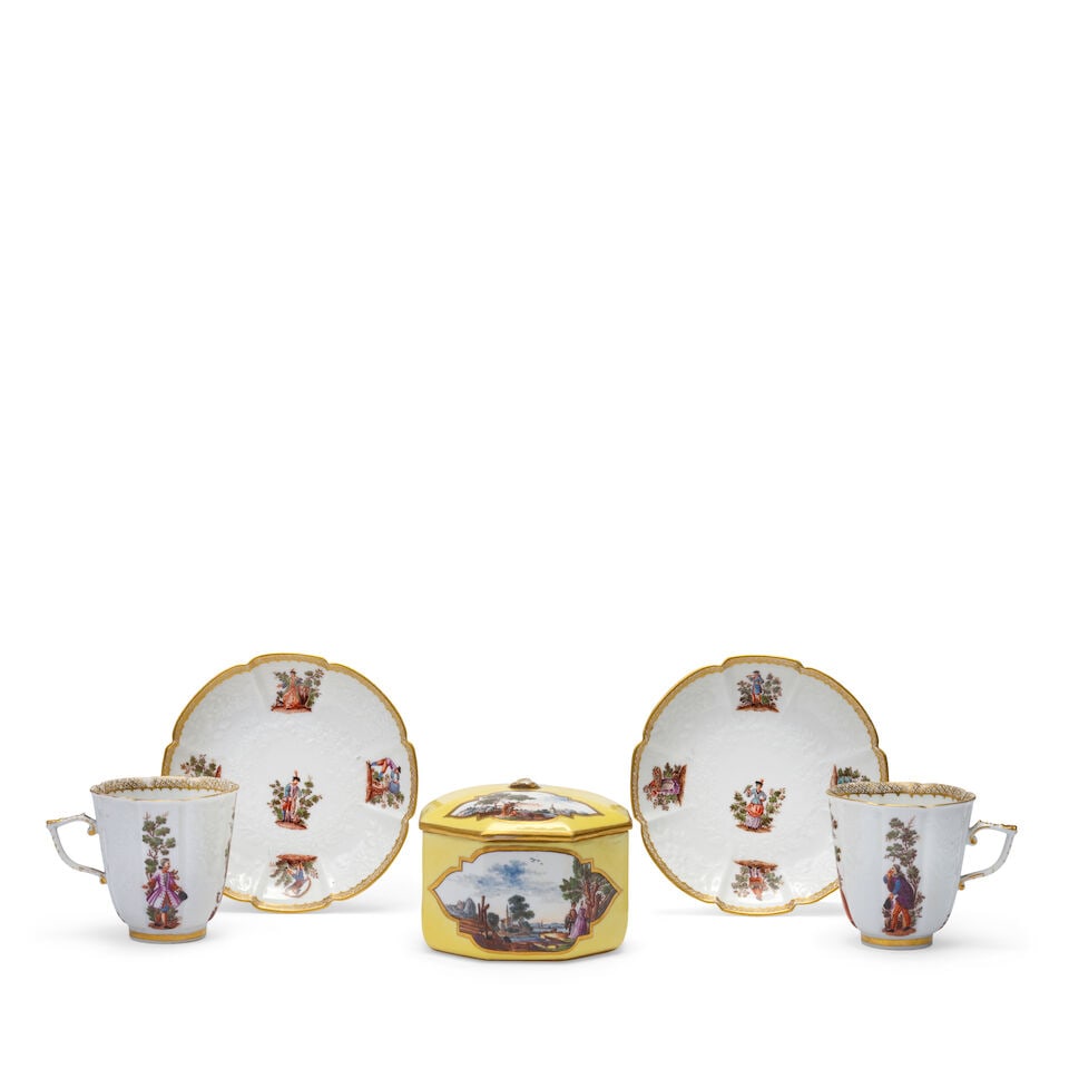 A Meissen yellow-ground octagonal sugar bowl and cover; together with two Meissen chocolate cups...: A Meissen yellow-ground octagonal sugar bowl and cover; together with two Meissen chocolate cups and saucers, first half 19th century The sugar bowl reserved with two gilt-edged shaped quatrelobe cart