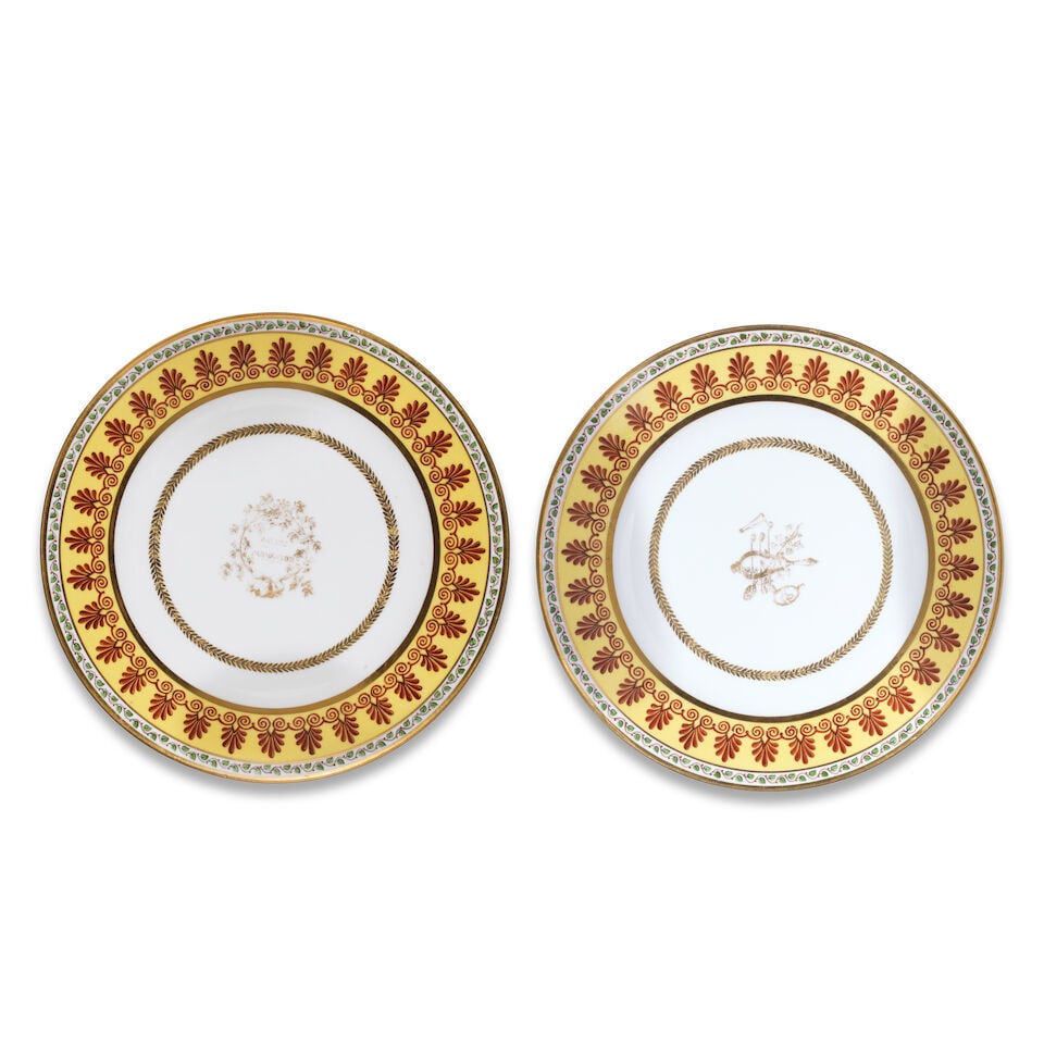Two Sèvres plates from a service delivered to Count Beugnot, dated 1823: Two Sèvres plates from a service delivered to Count Beugnot, dated 1823 Each with a yellow-ground rim painted with a brown border of palmettes and scrolls under a foliate border, gilt foliate