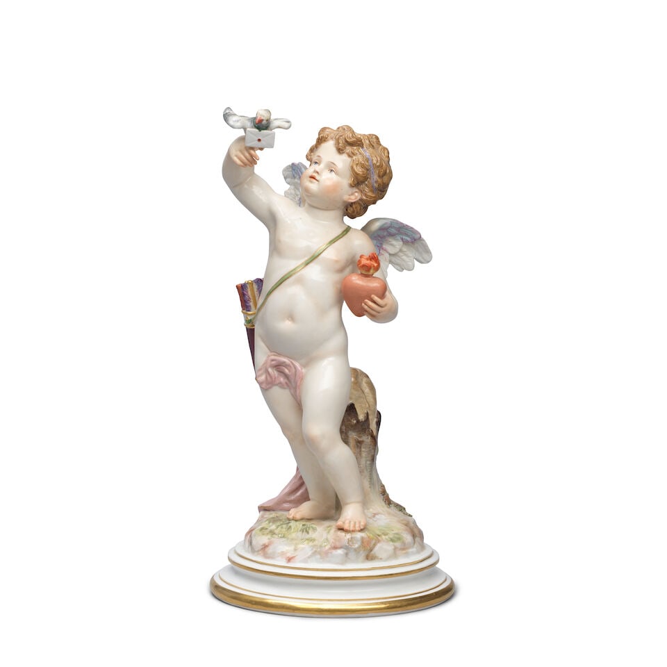 A Meissen large figure of a cupid, late 19th century: A Meissen large figure of a cupid, late 19th century Modelled by Johann Pollak, the winged cupid holding a pigeon with a letter tied to its neck in his right hand and a flaming heart in his left