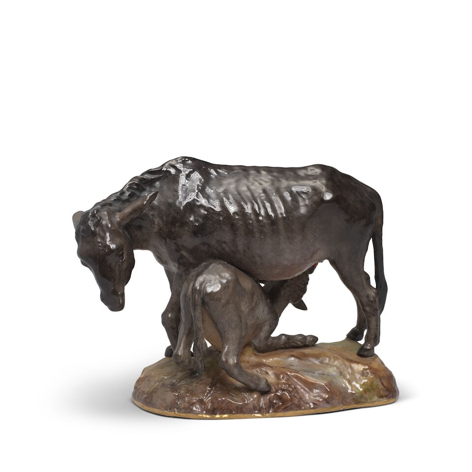 A rare Meissen group of a donkey and foal, late 19th century: A rare Meissen group of a donkey and foal, late 19th century After the 18th-century model by J.J. Kaendler and P. Reinicke, painted in shades of brown, the gilt-edged base shaded in brown and green,