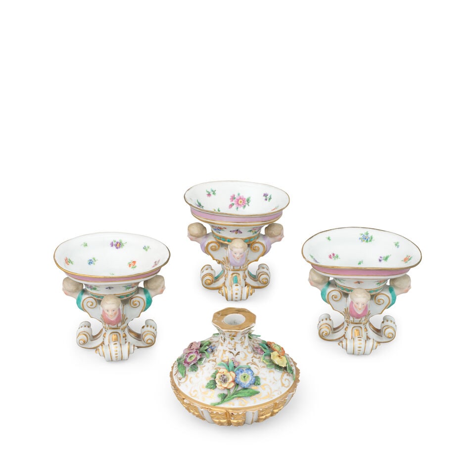 Three Meissen figural salts, together with a small Meissen vase, late 19th century: Three Meissen figural salts, together with a small Meissen vase, late 19th century Each oval salt on four scrollwork feet with masquaron terminals, painted with scattered flowers and insects, the smal