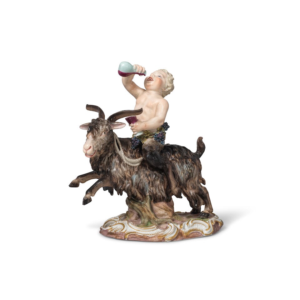 A late 19th century Meissen porcelain figure of a drunken Satyr riding a goat After the model by...: A late 19th century Meissen porcelain figure of a drunken Satyr riding a goat After the model by J.J. Kaendler of 1771 The satyr holding a goblet in his left hand and a bottle in the right, fruiting
