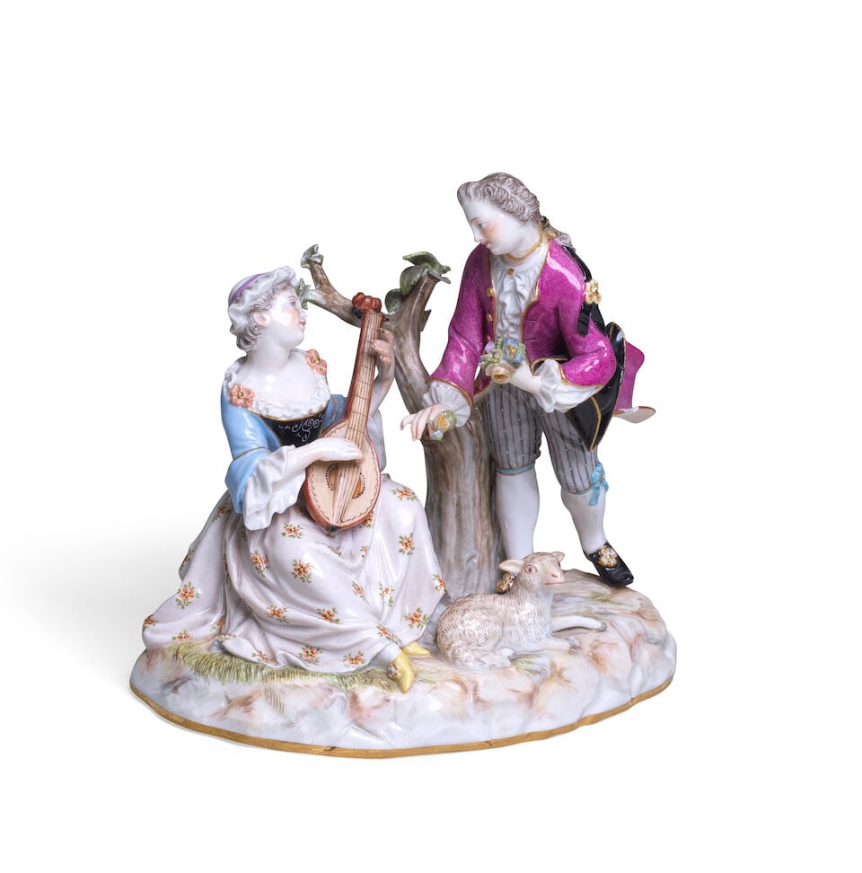 A Meissen group with a gallant couple, late 19th century: A Meissen group with a gallant couple, late 19th century The gentleman in a pink frock coat offering flowers to his interest, the lady wearing a blue bodice and flower-decorated white dress with bonne