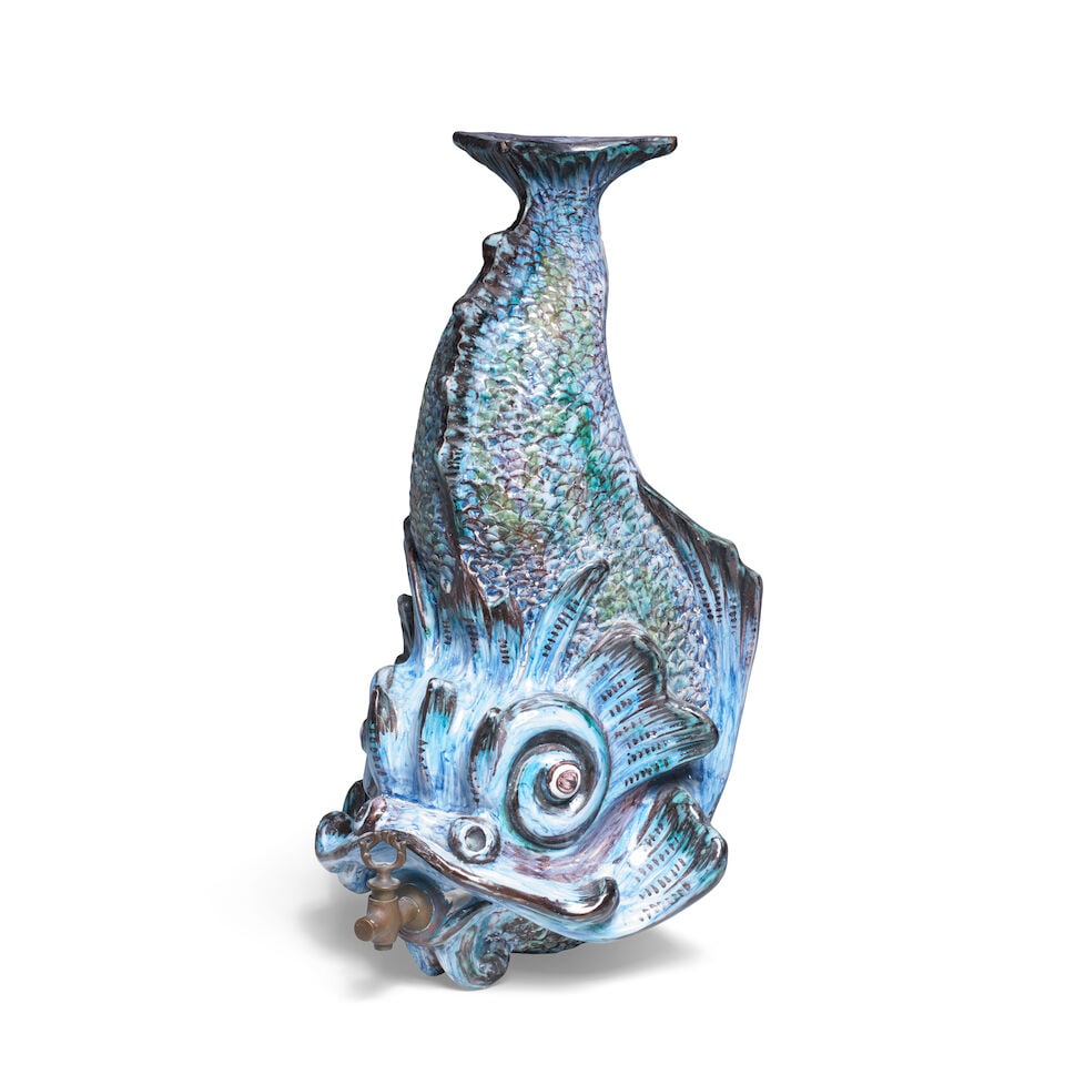 A faience wall cistern in the shape of a dolphin, possibly Brussels, 19th century: A faience wall cistern in the shape of a dolphin, possibly Brussels, 19th century Painted in shades of blue, manganese and green, mounted with a spigot in its mouth and moulded with a triangular apetu