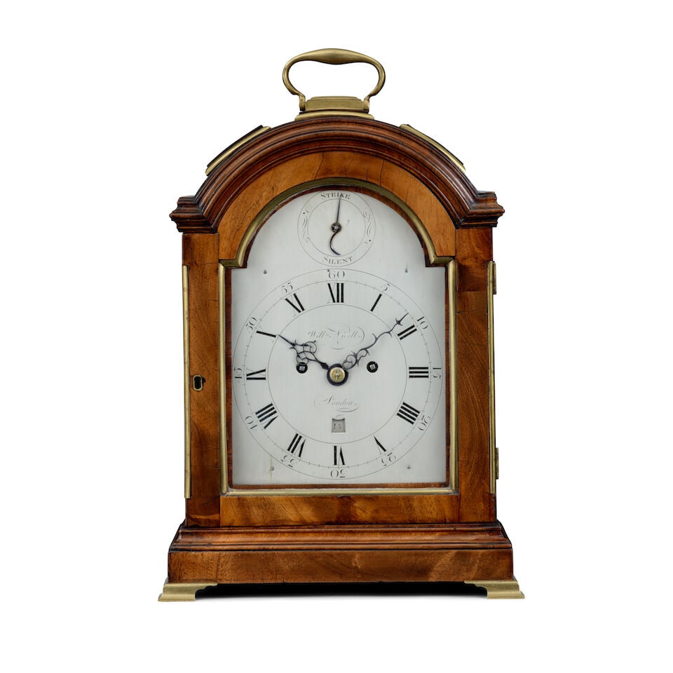 A late 18th century mahogany three pad striking table clock William Nicoll, London: A late 18th century mahogany three pad striking table clock William Nicoll, London The case surmounted by a brass carrying handle over three brass-mounted pads and a moulded top, the front with brass 