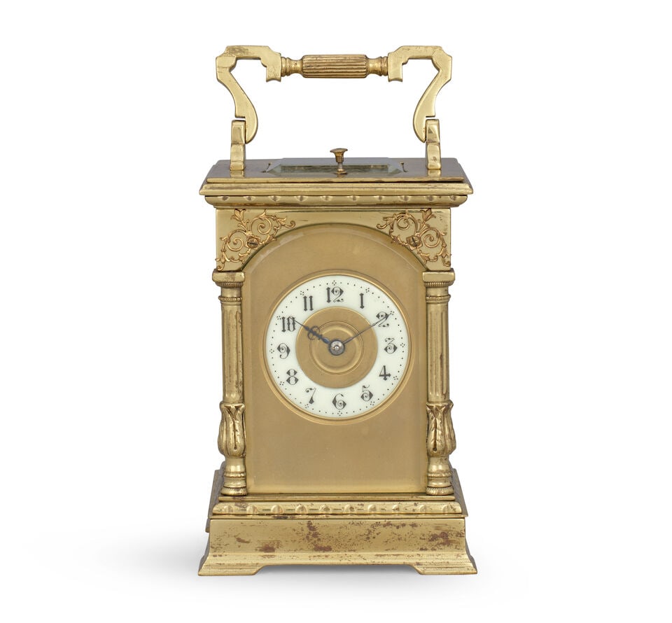 A late 19th century striking and repeating carriage clock R & Co., Paris: A late 19th century striking and repeating carriage clock R & Co., Paris The case sumounted by a shaped carrying handle over an observation window with decorated arched front and fancy supporting colu