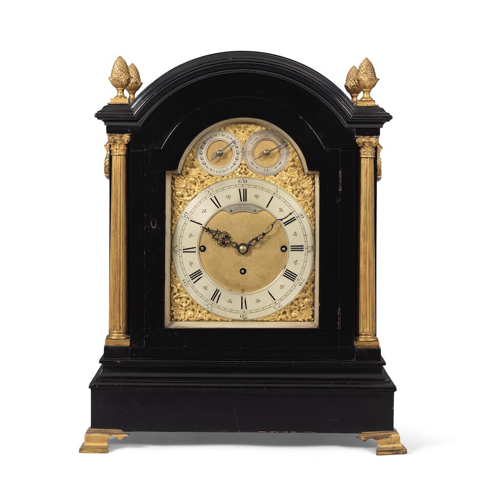 A large late 19th century ebonised quarter chiming table clock Dent, 33 Cockspur Street, London: A large late 19th century ebonised quarter chiming table clock Dent, 33 Cockspur Street, London The moulded break arch top with four large finials to each corner over a plain front, the sides with