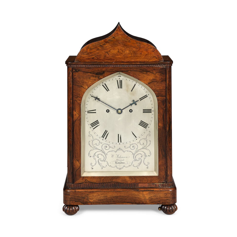 A mid 19th century mahogany veneered striking table clock William Johnson, Strand, London: A mid 19th century mahogany veneered striking table clock William Johnson, Strand, London The case with ogee top over a simple decorated cornice, the sides with stringing, the front with further