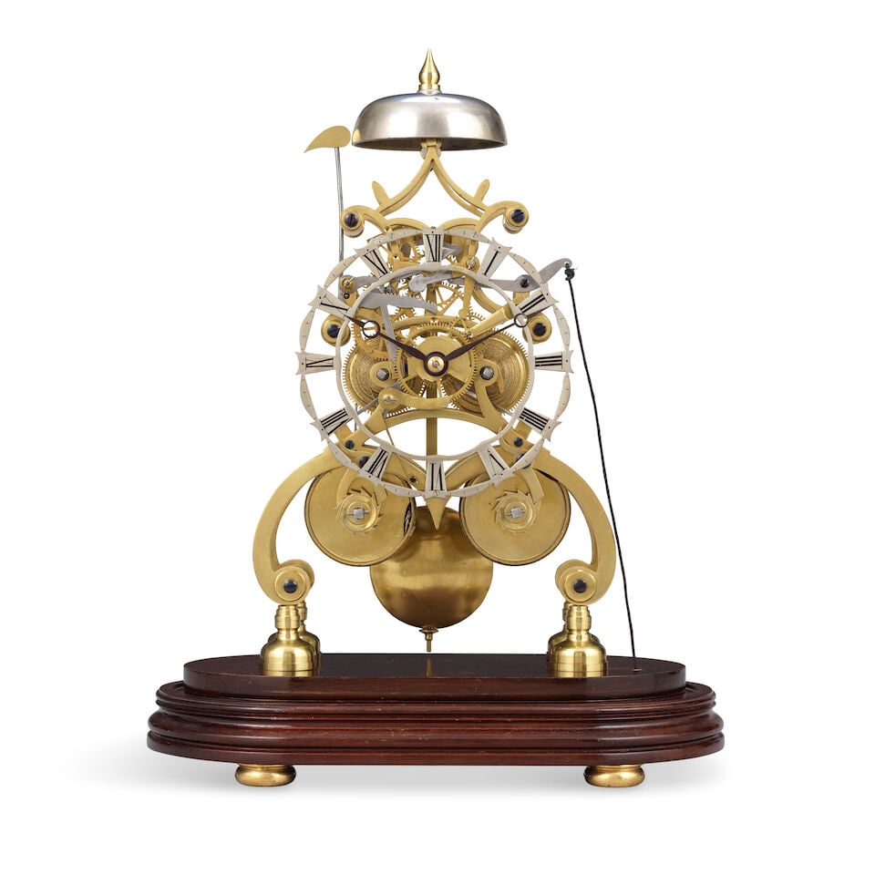 A late 19th century brass striking skeleton clock on later mahogany base: A late 19th century brass striking skeleton clock on later mahogany base The case set on a later mahogany base with brass bun feet. The 4.5 inch skeletonised silvered dial with Roman numerals and blue