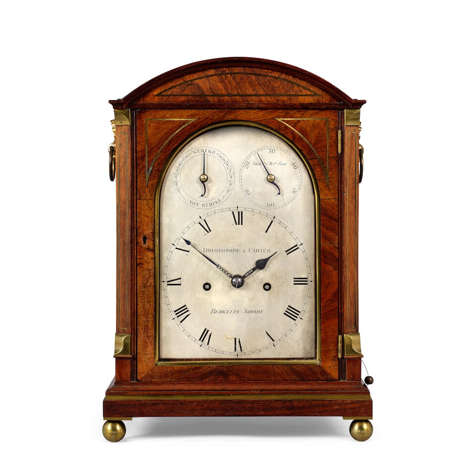 A good early 19th century mahogany and brass inlay striking table clock Dwerrihouse and Carter, ...: A good early 19th century mahogany and brass inlay striking table clock Dwerrihouse and Carter, Barclay Square The case with a sloped top above a moulded top with brass inlay to the architectural fron
