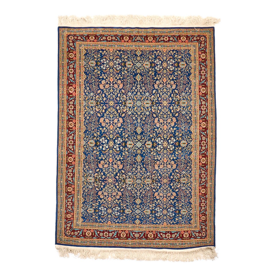 Hereke Rug Turkey 4 ft. 2 in. x 6 ft.: Hereke Rug Turkey c. 1930s, a luxurious and high-quality weave with a captivating indigo field framed by a flowery madder border. 4 ft. 2 in. x 6 ft. For further information on this lot please visit B