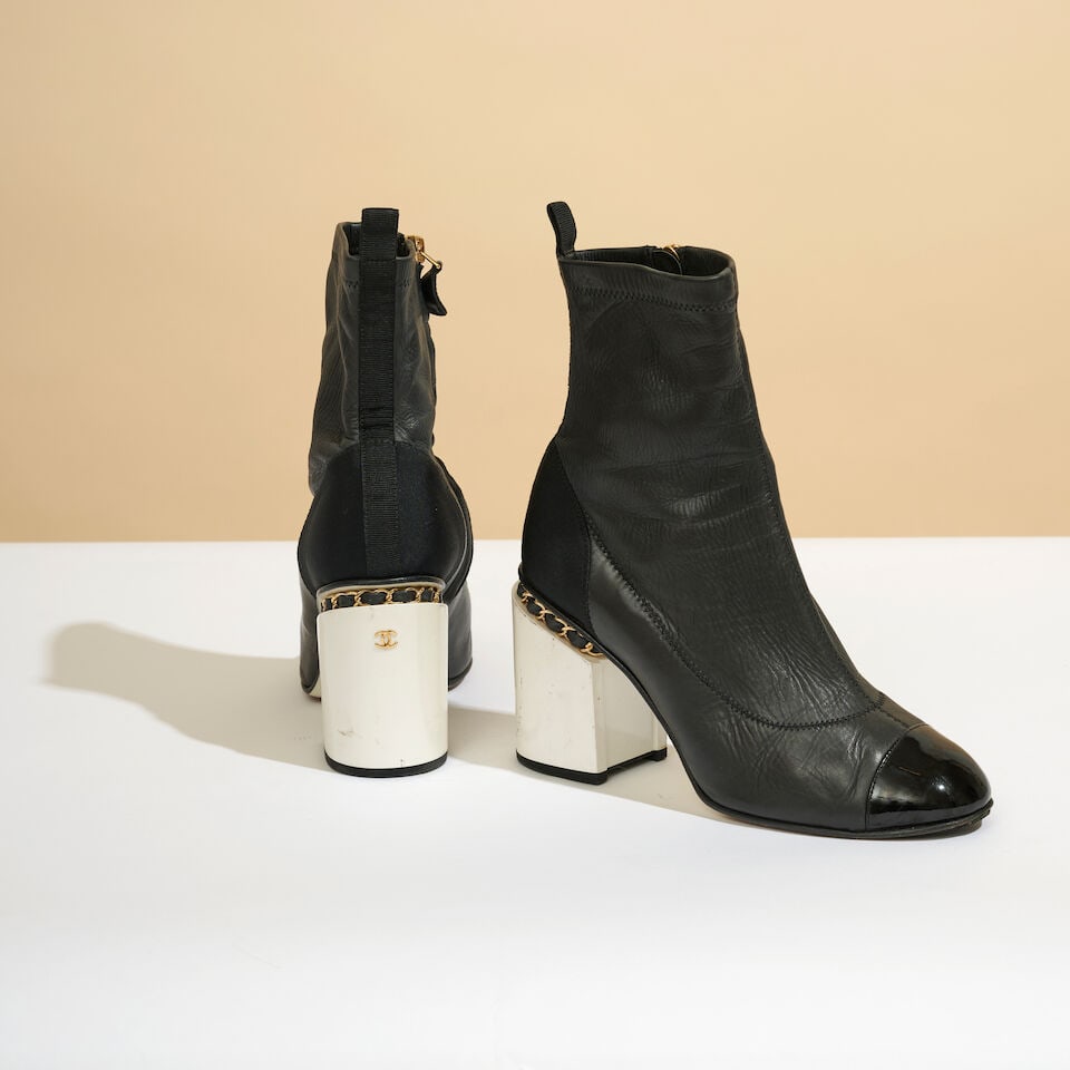 Chanel. Bottines en cuir vieilli, partiellement vernis noir, à talons en bakélite iris...: Chanel. Bottines en cuir vieilli, partiellement vernis noir, à talons en bakélite irisé blanc perle. Chanel. Ankle boots in partially patent black leather, with iridescent pearl-white