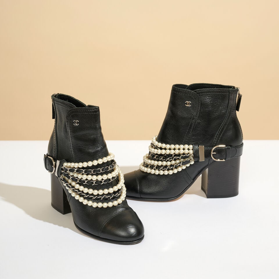 Chanel. Bottines à talons en cuir noir à boucle amovible de perles d'imitation et chai...: Chanel. Bottines à talons en cuir noir à boucle amovible de perles d'imitation et chaines. Chanel. Black leather heeled ankle boots with a detachable faux-pearl and chain buckle. Pointure in