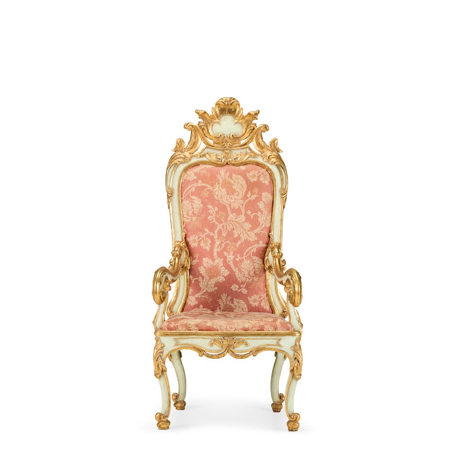 A large Italian 18th century painted and parcel gilt 'throne' type armchair: A large Italian 18th century painted and parcel gilt 'throne' type armchair The cartouche shaped panelled back carved with c- and s-scrolled acanthus adornments, surmounted by a trefoil tablet-inset