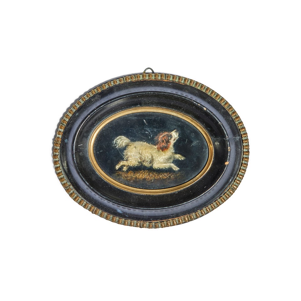 A 19th century painted papier-mâché miniature oval picture of spaniel: A 19th century painted papier-mâché miniature oval picture of spaniel The playful hound with upturned face and depicted mid leap, in an ebonised and gilt frame, the reverse with small suspen