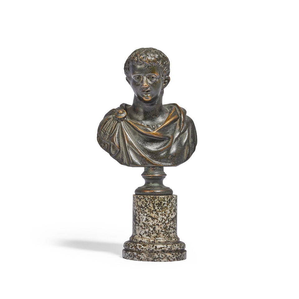 A 19th century patinated bronze bust of a Roman Emperor Probably depicting Augustus Caesar: A 19th century patinated bronze bust of a Roman Emperor Probably depicting Augustus Caesar Clad in classical attire, raised on a moulded granite column plinth base, 19.5cm high, 9.5cm wide, 7cm deep
