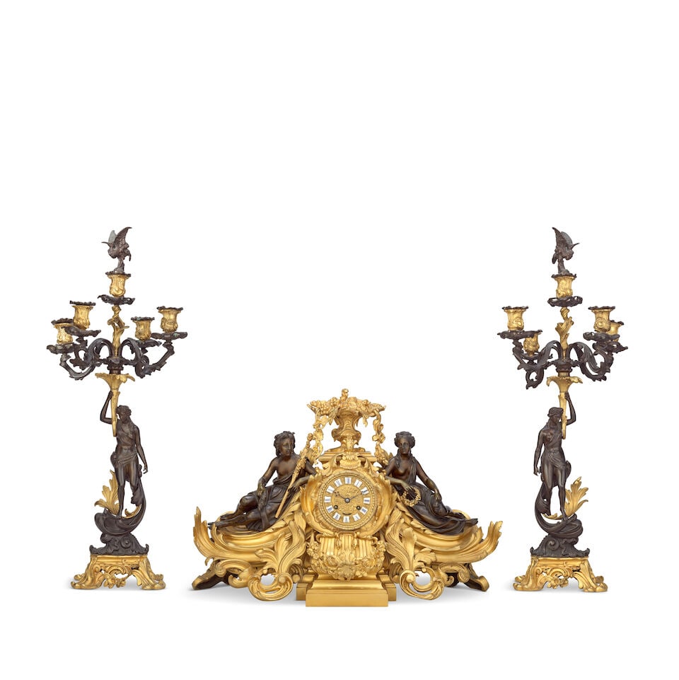 A good third quarter 19th century French gilt and patinated bronze figural clock garniture The m... (1 of 1)