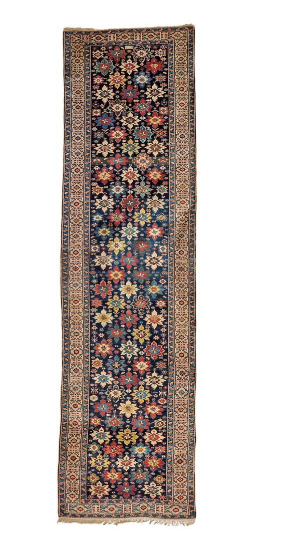A Kuba runner C.1870, East Caucasus 426cm x 115cm overall: A Kuba runner C.1870, East Caucasus Designed with recurring star motifs, on rich indigo ground, signed to one end, 426cm x 115cm overall Footnotes: Provenance Alexander Juran, 1974. Property of a