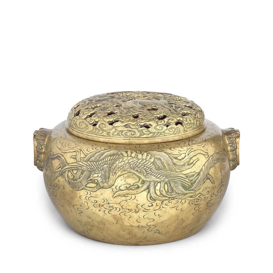 A large bronze incense burner and cover Japan, 20th century: A large bronze incense burner and cover Japan, 20th century Cast in relief to each side with a large phoenix amongst cloud scrolls, the body flanked by a pair of lion mask handles with wide open