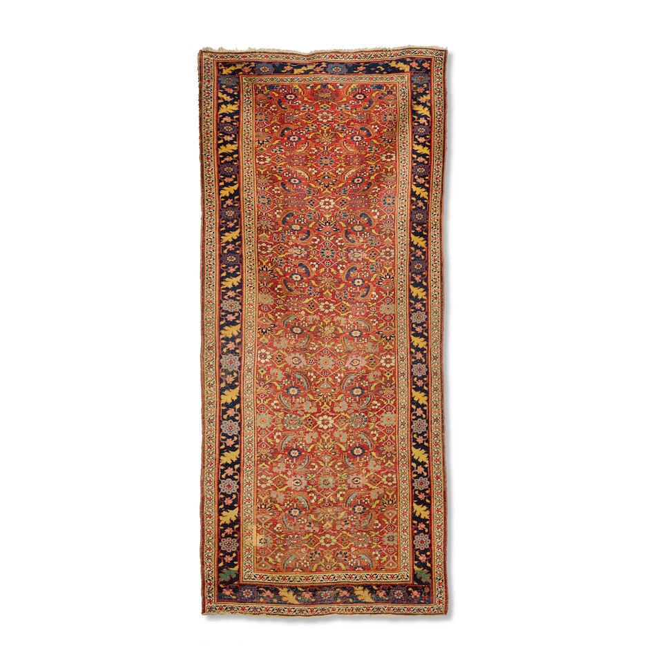A Bidjar long rug West Persia 345cm x 151cm: A Bidjar long rug West Persia The madder ground with allover herati design, enclosed by indigo borders with stylised floral and foliate motifs, 345cm x 151cm Footnotes: Please note that this lot is