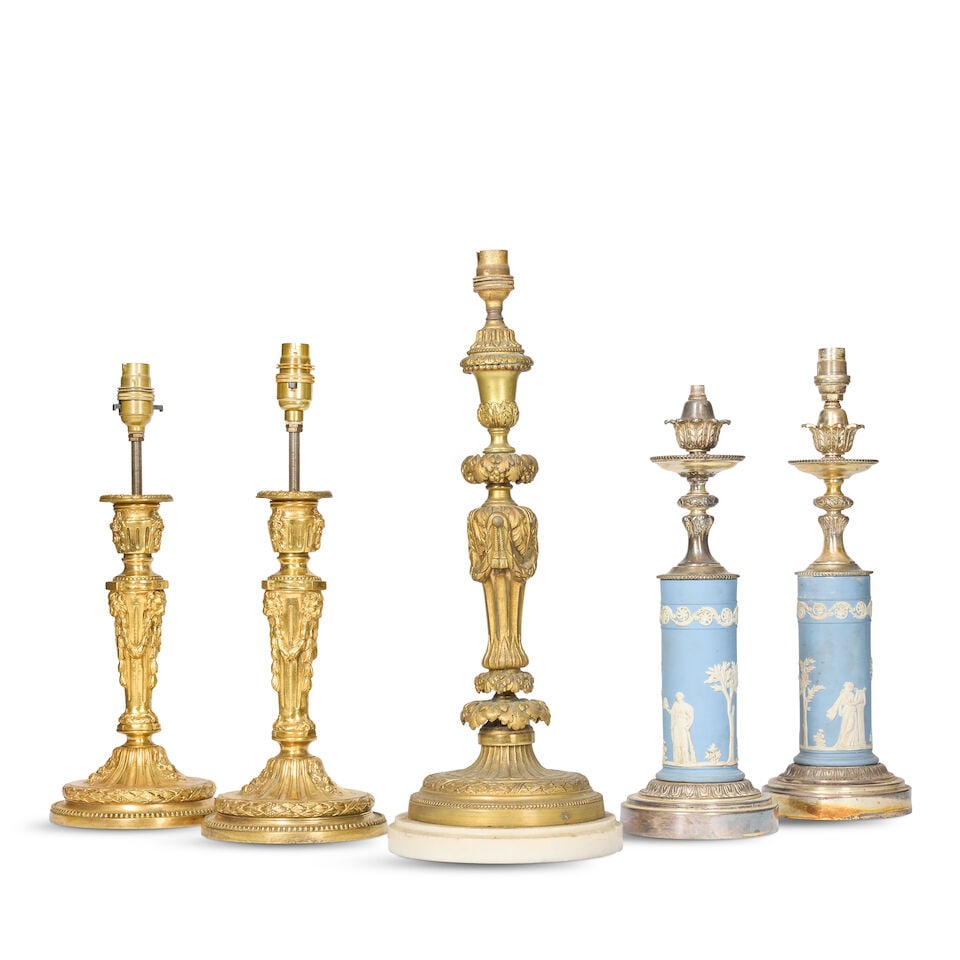 A pair of French gilt bronze candlesticks later adapted as lampbases, a similar larger gilt bron... (1 of 2)