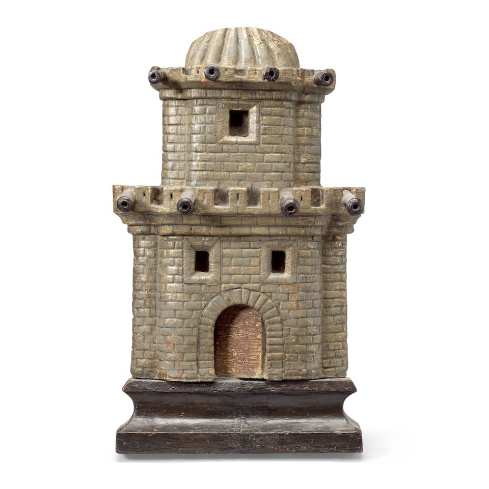 A 17th century Spanish carved, painted and gilt decorated wood relief of a castle and turret fa&...: A 17th century Spanish carved, painted and gilt decorated wood relief of a castle and turret façade Modelled with a domed and lobed roof, with cannons through the battlements, the door ajar, rais