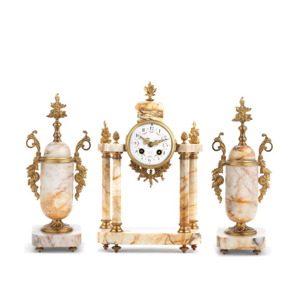 An early 20th century French gilt bronze and onyx portico clock garniture (3): An early 20th century French gilt bronze and onyx portico clock garniture (3) The clock surmounted by a domed cupola with floral finial on column supports with floral and pineapple finials, the platfo