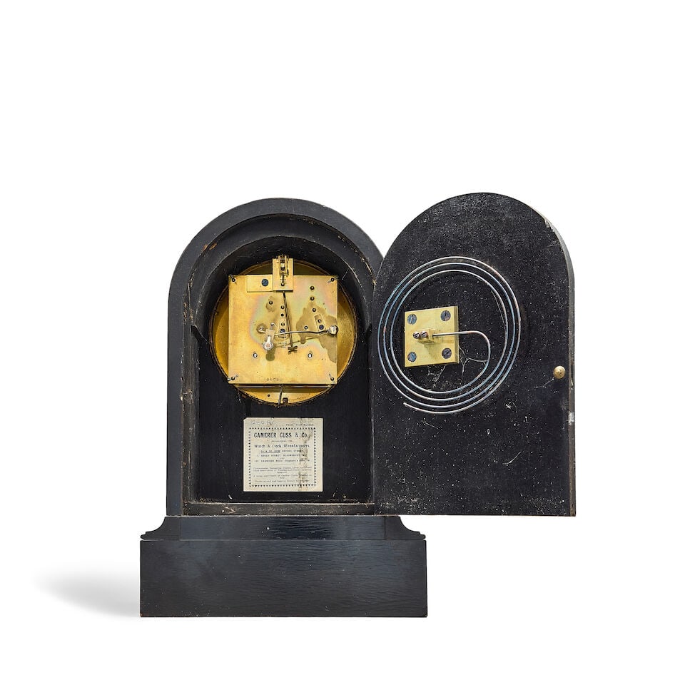 A mahogany wall clock together with an ebonised table clock, a small brass skeleton timepiece wi... - 2