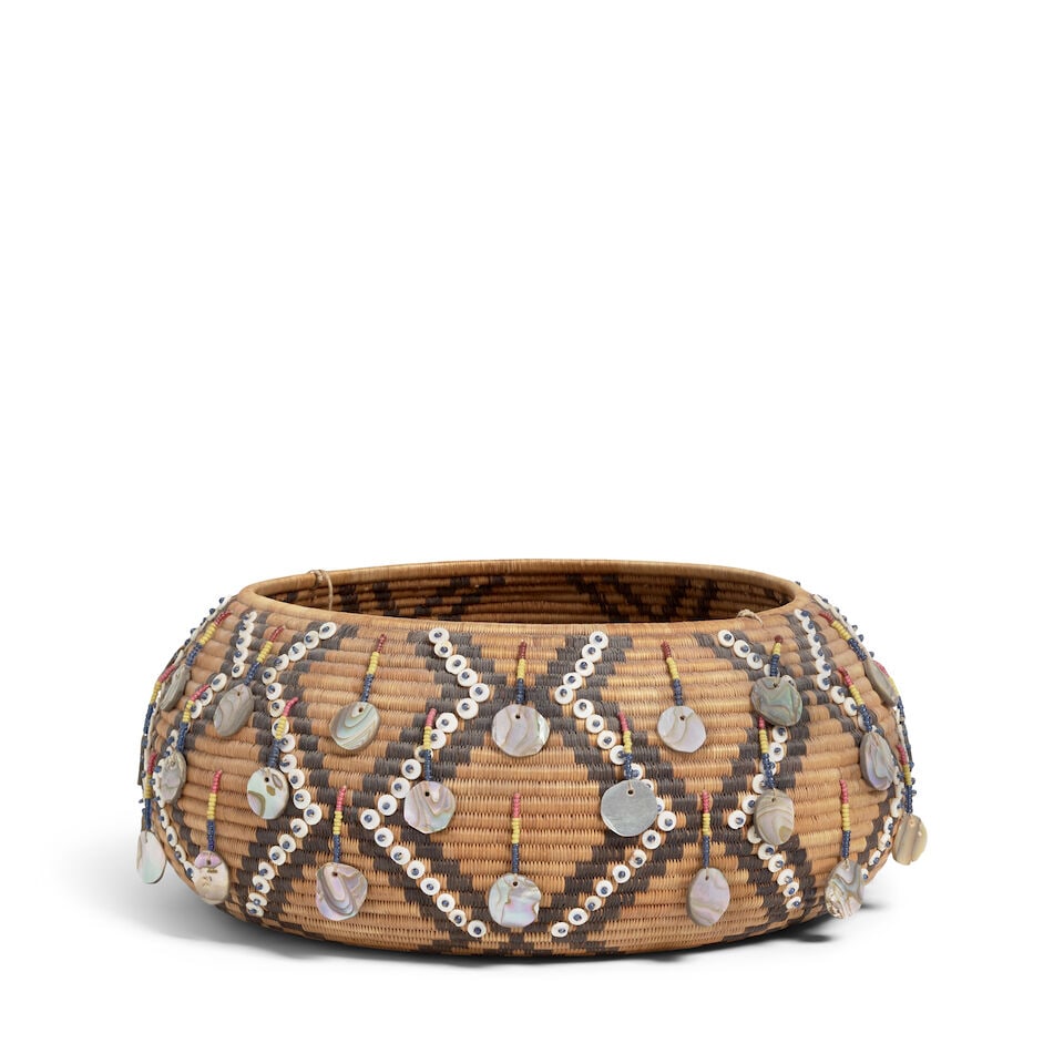 A Pomo gift basket: A Pomo gift basket Woven and decorated in a diamond latticework pattern, with disc and glass seed beads, beaded drops with disc suspensions, a disc-beaded twine handle, a seven-point star at the