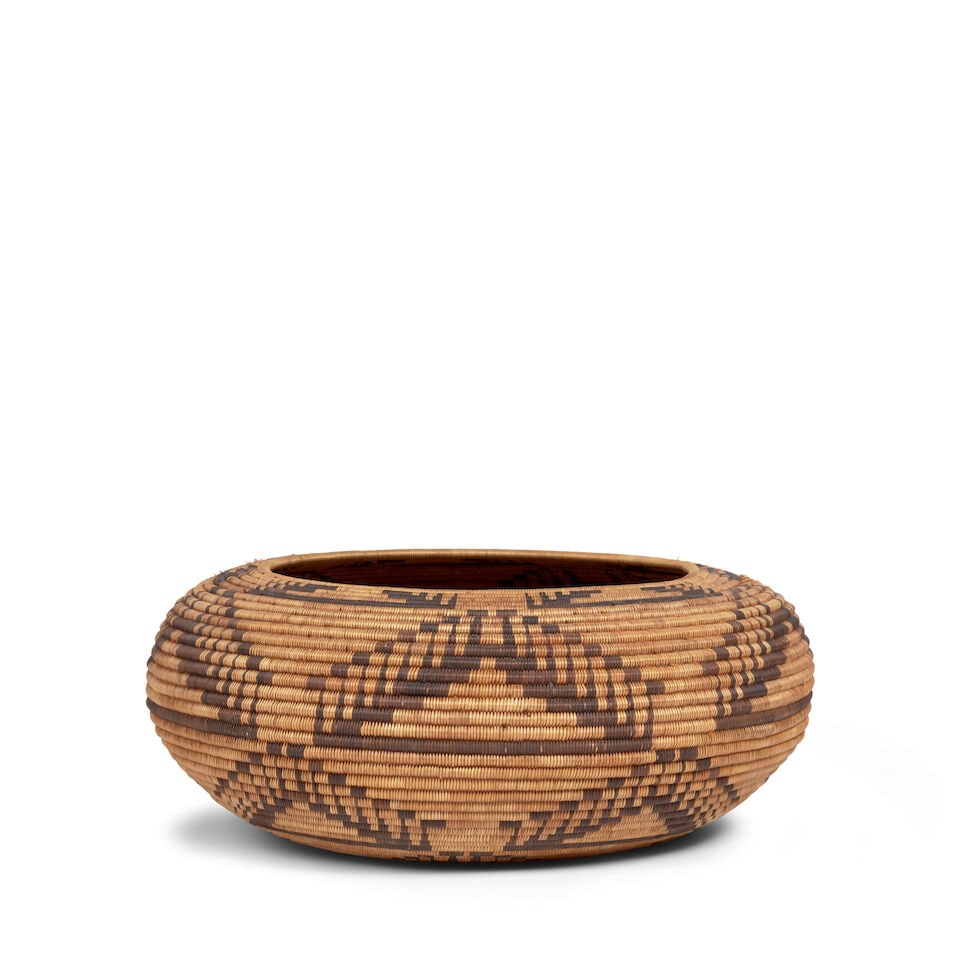 A Pomo basket: A Pomo basket Worked in a repeat pattern with rows of stepped triangles with topknot motif appendages, checkered bands at the base. diameter 10 5/8in, height 4