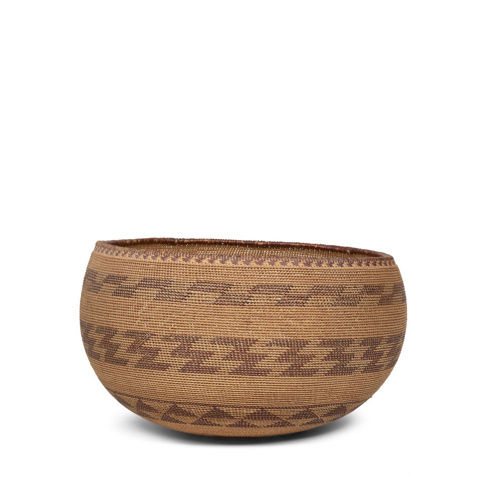 A large Pomo basket: A large Pomo basket A rare open lattice twined example, a ring of parallelograms below the rim, rows of zigzags and triangle motifs below the shoulder, another ring of parallelograms at the