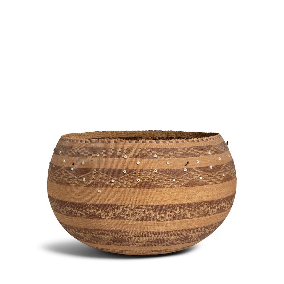 A large Pomo basket: A large Pomo basket The twined bamtush bowl worked with finely woven bands of distinctive stepped and serrated geometric motifs, with disc bead and quail topknot accents. diameter 19 1/4in, height 12