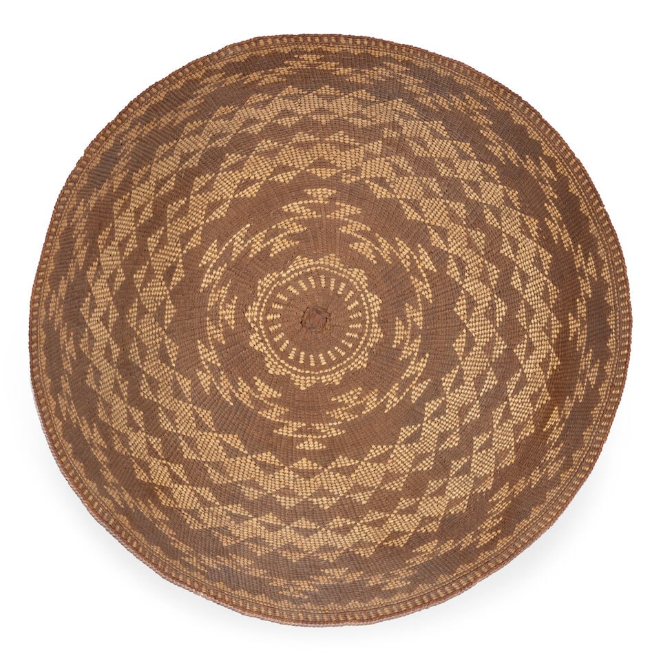 A Hupa gambling tray: A Hupa gambling tray Woven with dense bands of triangular and diamond motifs. diameter 19in, height 6in Footnotes: Provenance Kania-Ferrin Gallery, Santa Fe, NM A Private Midwest Collection, acquired