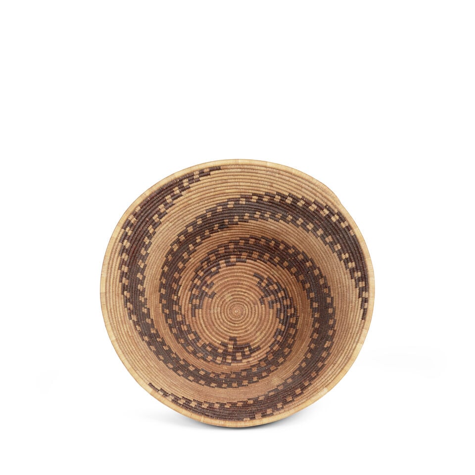 A Patwin basket, attributed to Molly Wright: A Patwin basket Attributed to Molly Wright (20th century), a trio of finely hooked diagonals creating a continuous spiral pattern. diameter 12 5/8in, height 6 1/4in Footnotes: The attribution to