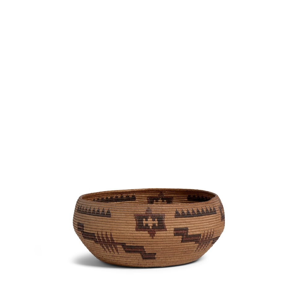 A Washoe polychrome basket: A Washoe polychrome basket Woven with four repeat registers including serrated and fretwork bands alongside a complex geometric lozenge, a period label at the base reading: 'Old Washoe /
