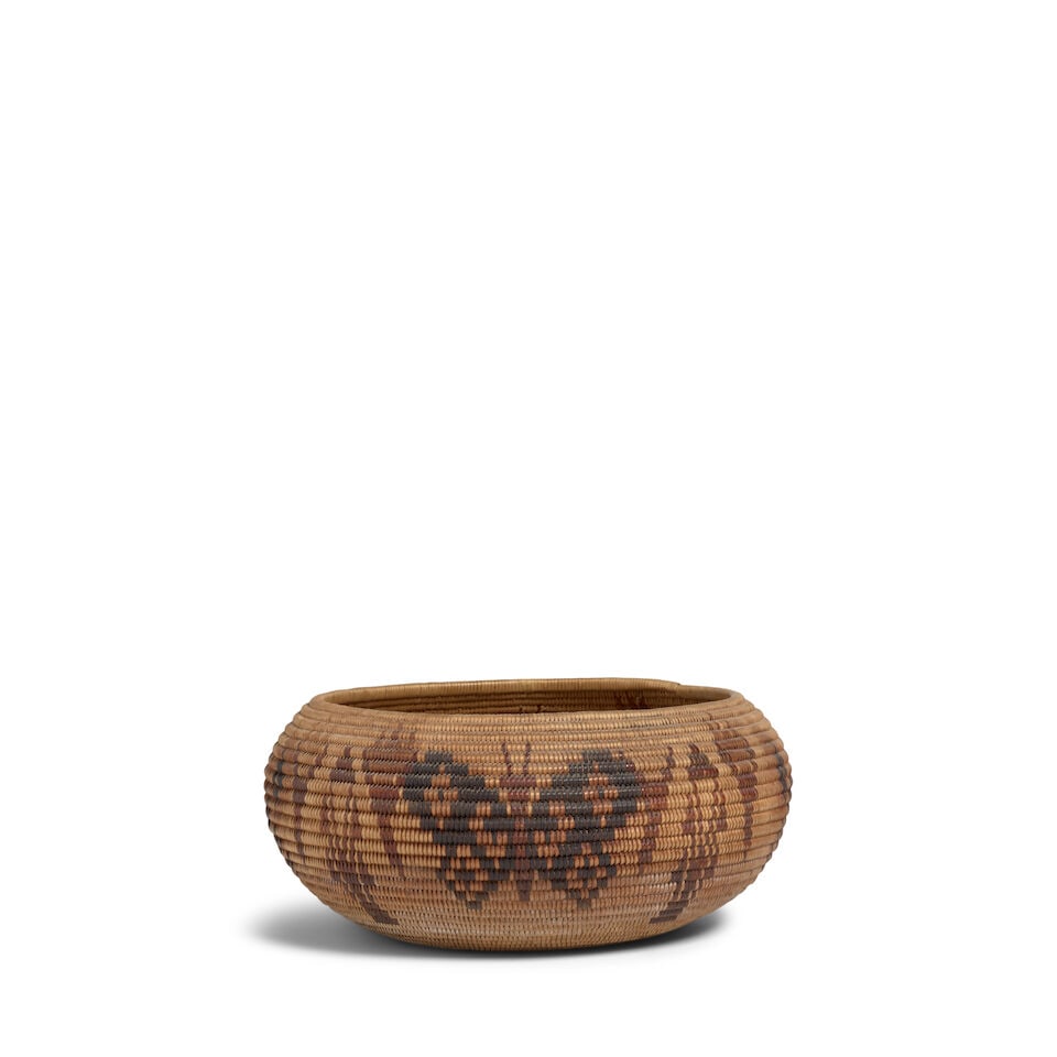 A Washoe polychrome pictorial basket: A Washoe polychrome pictorial basket Alternating butterflies with floral blossoms and stylized plant forms. diameter 9in, height 4 1/4in Footnotes: Provenance Kania-Ferrin Gallery, Santa Fe, NM A