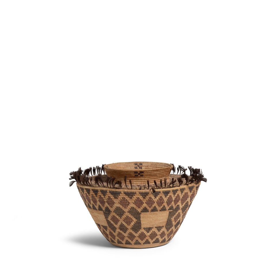 A Yokuts polychrome bottleneck basket: A Yokuts polychrome bottleneck basket Variant rattlesnake patterns about the body and at the base of the neck, four undecorated quadrants at the midpoint, small checkerboard motifs below the rim. diam