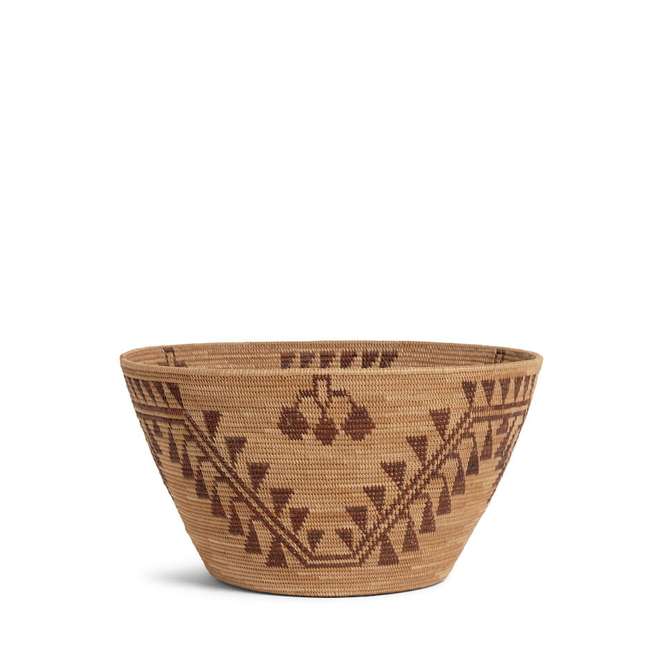 A Yokuts basket, attributed to Minnie Hancock Wilcox: Minnie Hancock Wilcox (attributed) Wukchumni Yokuts, (1892-1952), woven with a fretwork meander adorned with dense triangular fringe, triple-lobed lozenges as filler devices. diameter 9 1/4in, height