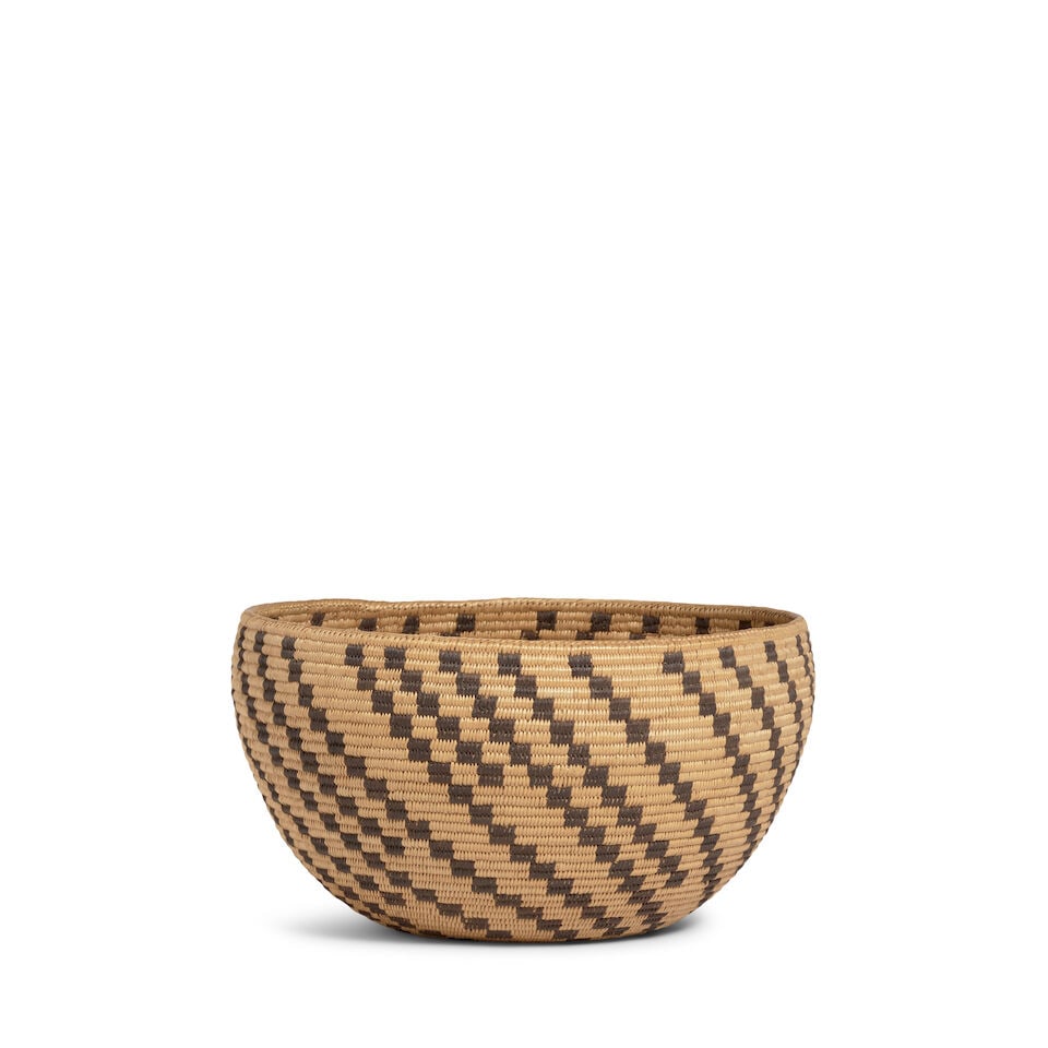 A Paiute basket: A Paiute basket The deep bowl woven with a series of diagonal stepped bands of varying lengths descending from the rim. diameter 8 1/2in, height 4 3/4in Footnotes: Notes on this basket by Ella Cain