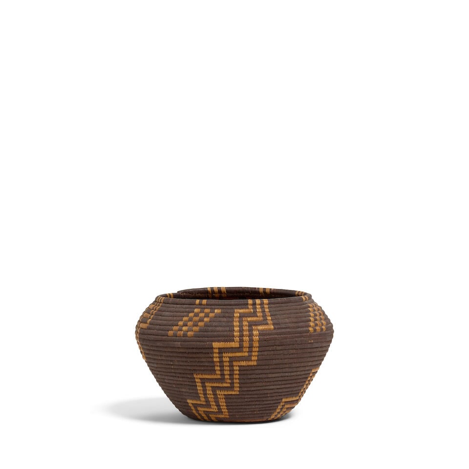 A Panamint Shoshone (Timbisha) ovoid negative basket: A Panamint Shoshone (Timbisha) ovoid negative basket Fretwork zigzags radiating from the banded base, checkerboard diagonals as filler devices above the shoulder. dimensions 6 x 5 5/8 x 3 1/2in Footno