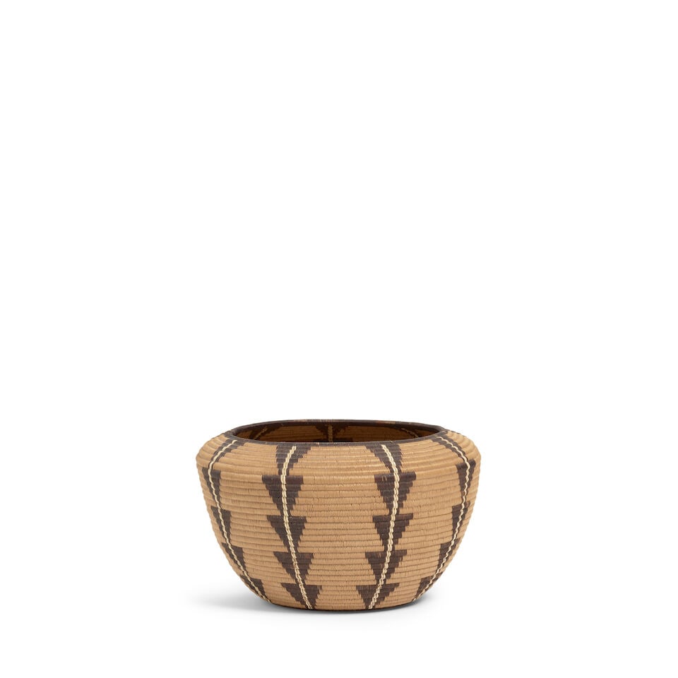 A Panamint Shoshone (Timbisha) polychrome basket: A Panamint Shoshone (Timbisha) polychrome basket A finely woven example, columns of stacked triangles rising from a seven-pointed floriform design at the base. diameter 5 7/8in, height 3