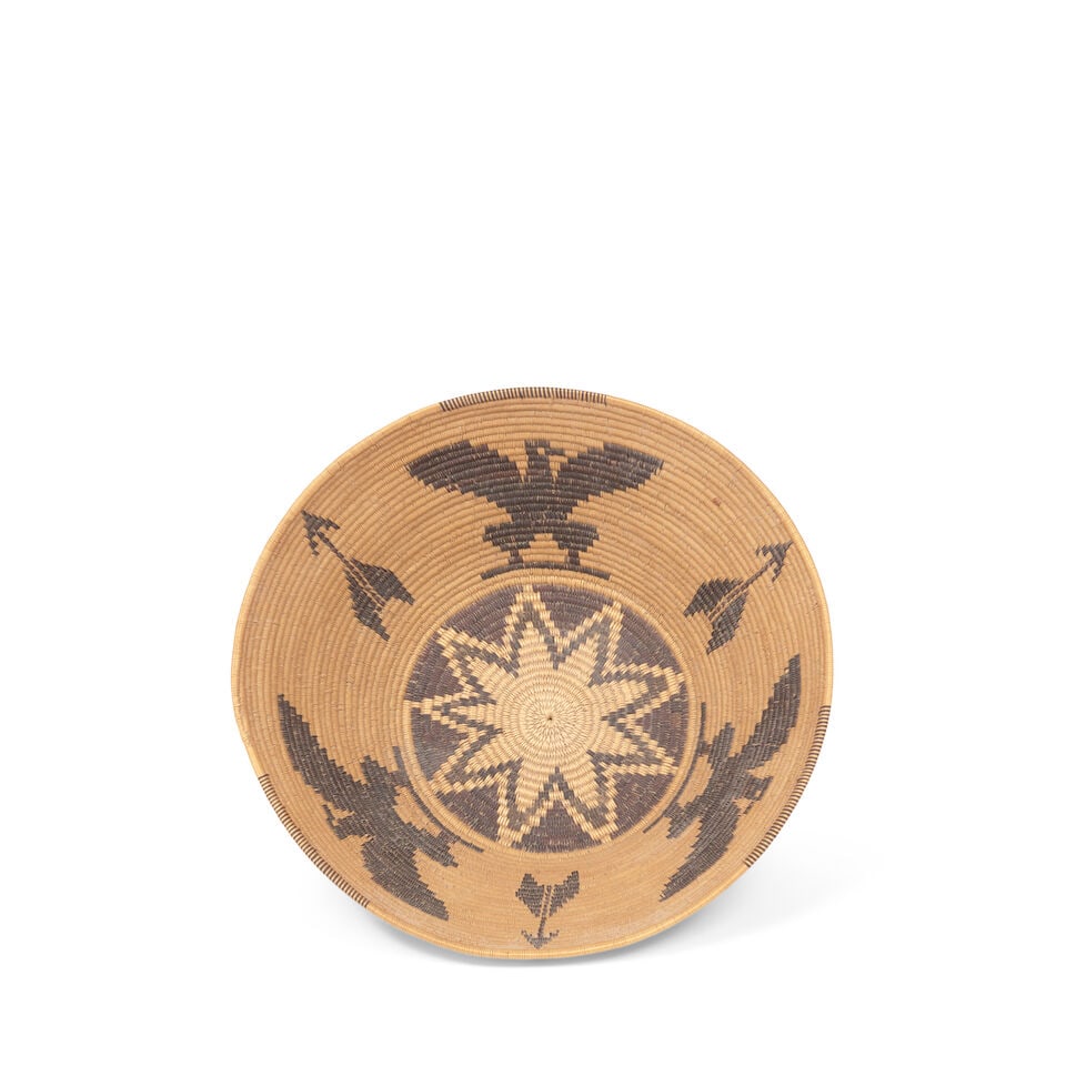 A Panamint Shoshone (Timbisha) polychrome pictorial basket: A Panamint Shoshone (Timbisha) polychrome pictorial basket Alternating spread-winged Federal eagles and large arrows, a nine-pointed star at the base. diameter 7 1/2in, height 2